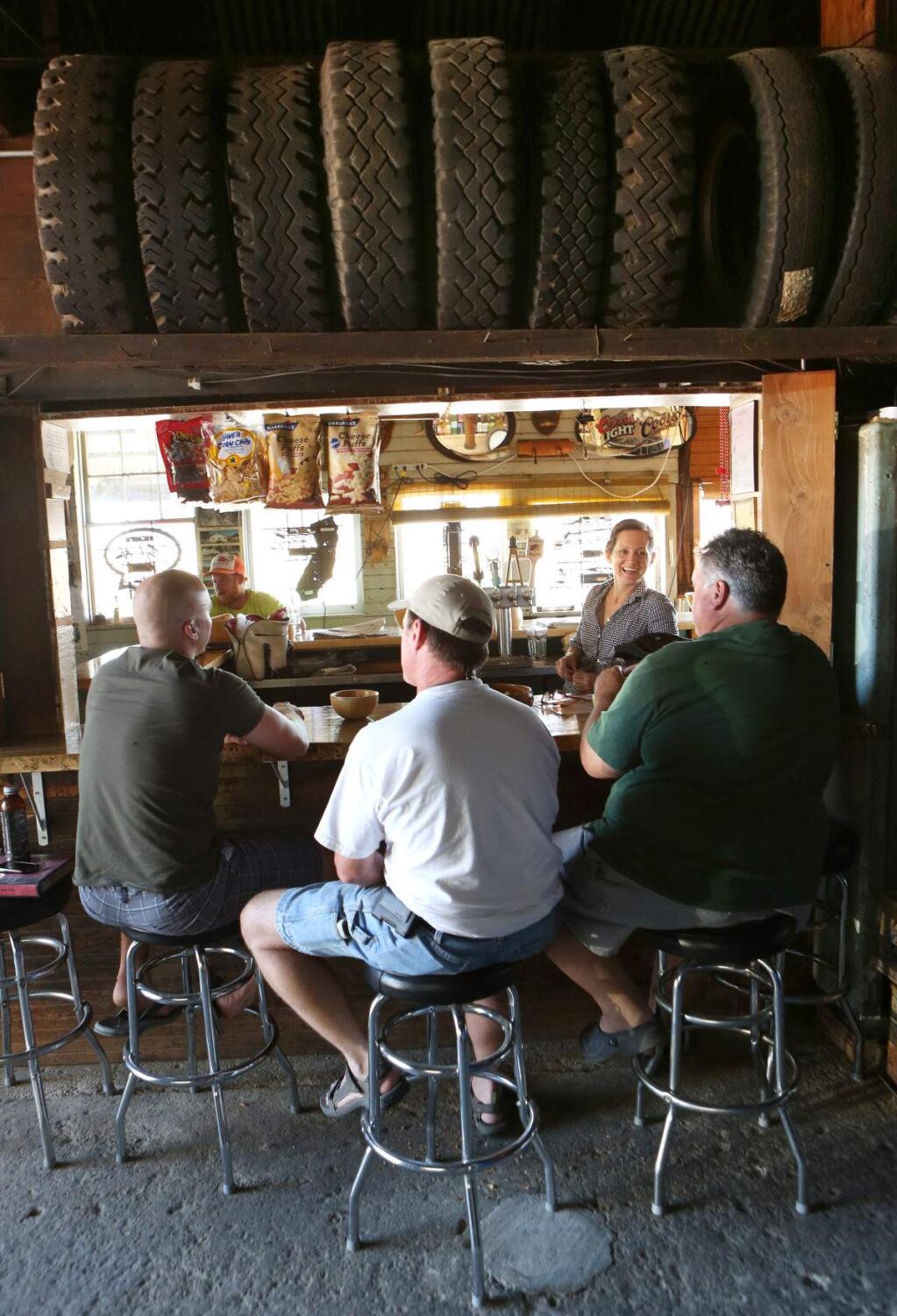 8/3/2013: T1:PC: An overflow crowd sits in garage in the back of Ernie's Tin Bar in Petaluma on Thursday, July 18, 2013. (Conner Jay/The Press Democrat)