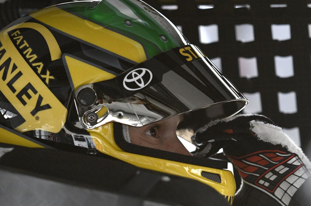 Daniel Suarez looks on in his car before practice for the NASCAR Cup series auto race, Saturday, June 3, 2017, at Dover International Speedway in Dover, Del. (AP Photo/Nick Wass)