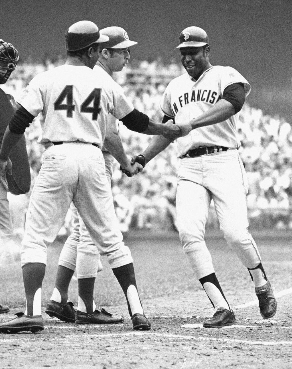 In this July 23, 1969, file photo, the National League's Willie McCovey of San Francisco is congratulated on crossing home in the third inning of the All-Star Game in Washington after batting in Hank Aaron (44). (AP Photo, File)