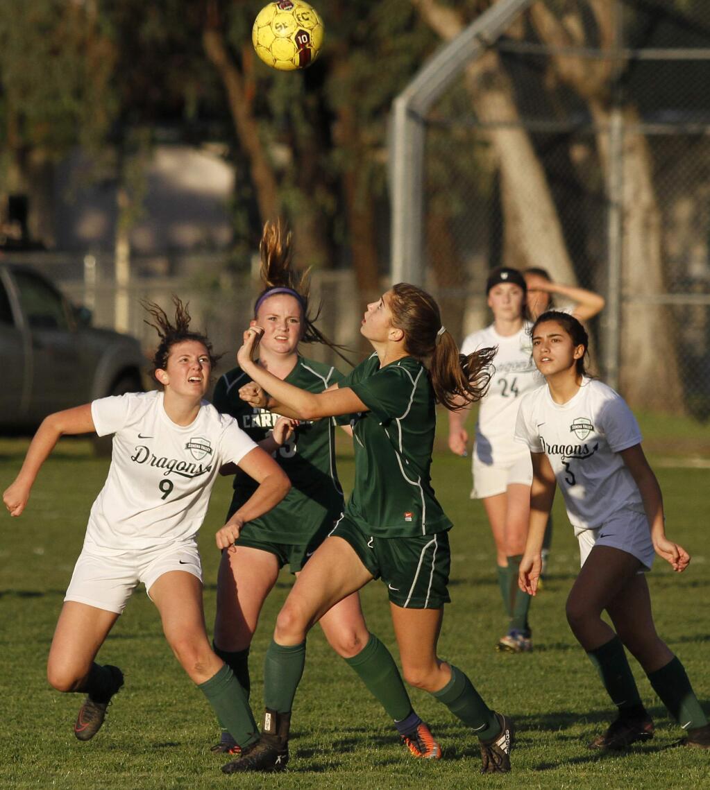 Bill Hoban/Index-TribuneLady Dragons Lucy Sondheim (#9) and Alexia Contreras (#3)wait for a header to fall during Thursday's game against Maria Carrillo. The Lady Dragons lost to the Pumas, 4-0.