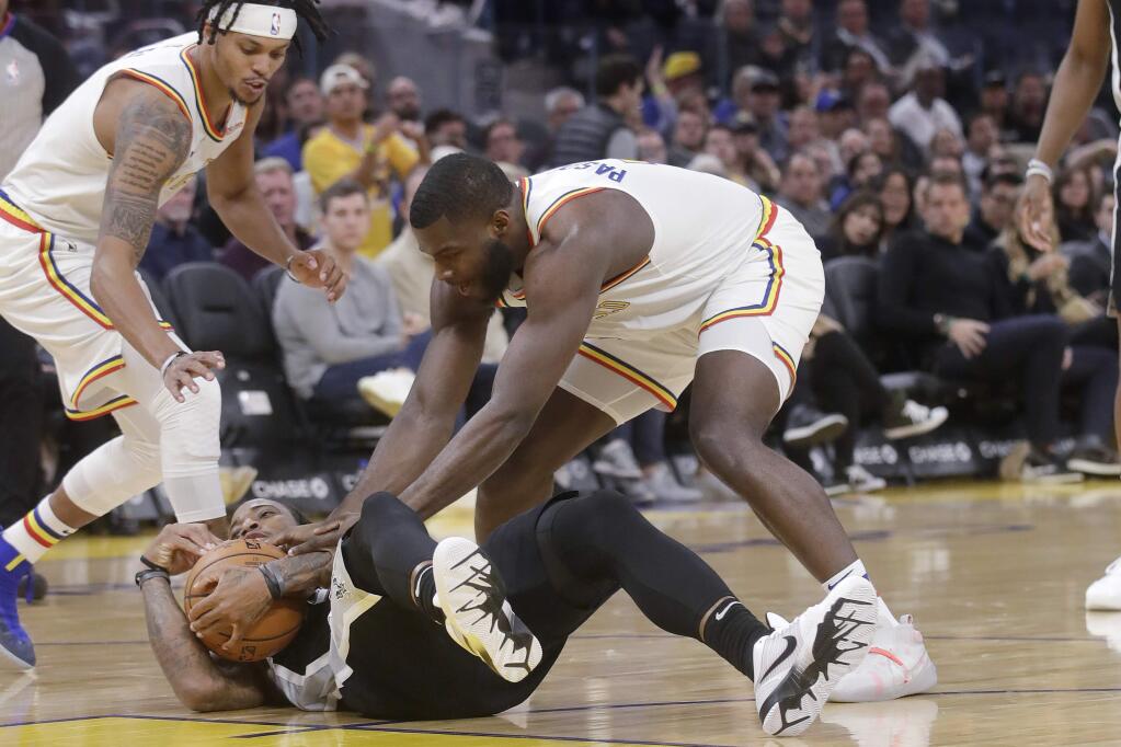 San Antonio Spurs guard DeMar DeRozan, bottom, tries to hold on to the ball under Golden State Warriors forward Eric Paschall, left, and guard Damion Lee during the second half in San Francisco, Friday, Nov. 1, 2019. (AP Photo/Jeff Chiu)