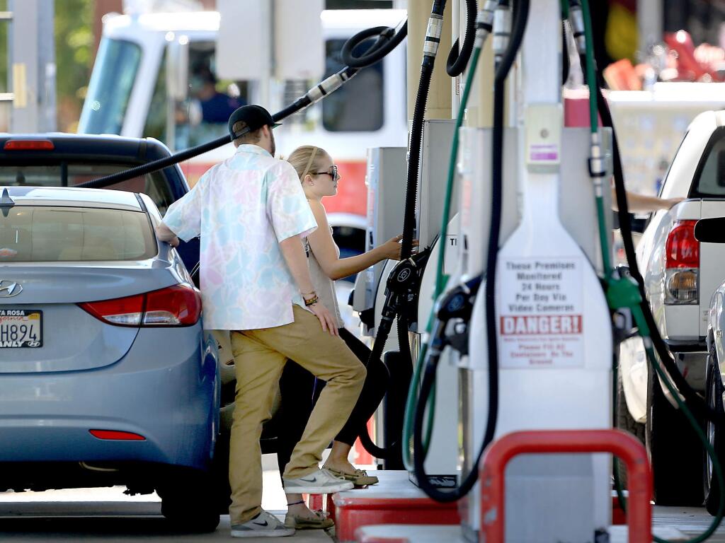 Customers buy fuel at the Safeway gas station in Santa Rosa, Tuesday July 14, 2015 in Santa Rosa. (Kent Porter / Press Democrat) 2015