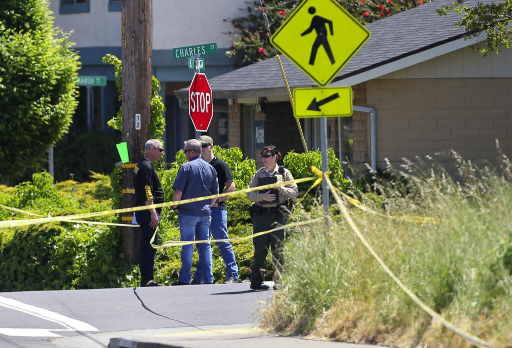 Sonoma County Sheriff's Office law enforcement personnel meet on the corner of Charles Street and East Cotati Avenue, as they investigate a shooting in Cotati on Friday, May 5, 2017. (Christopher Chung/ The Press Democrat)