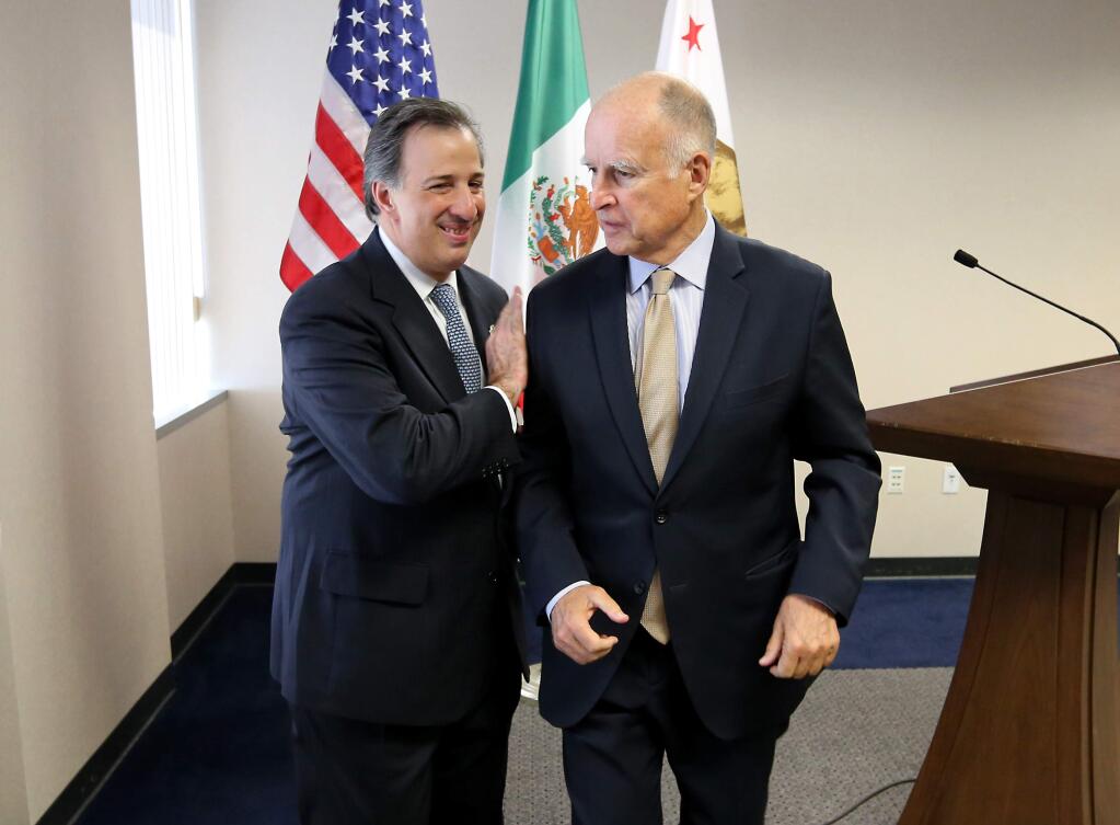 Gov. Jerry Brown, right, and Mexican Secretary of Foreign Affairs Jose Antonio Meade Kuribrena leave a news conference after talking with reporters Wednesday, July 23, 2014, in Sacramento, Calif. Brown and Meade attended a luncheon hosted by the California Chamber of Commerce, where they discussed Brown's upcoming visit to Mexico.(AP Photo/Rich Pedroncelli)