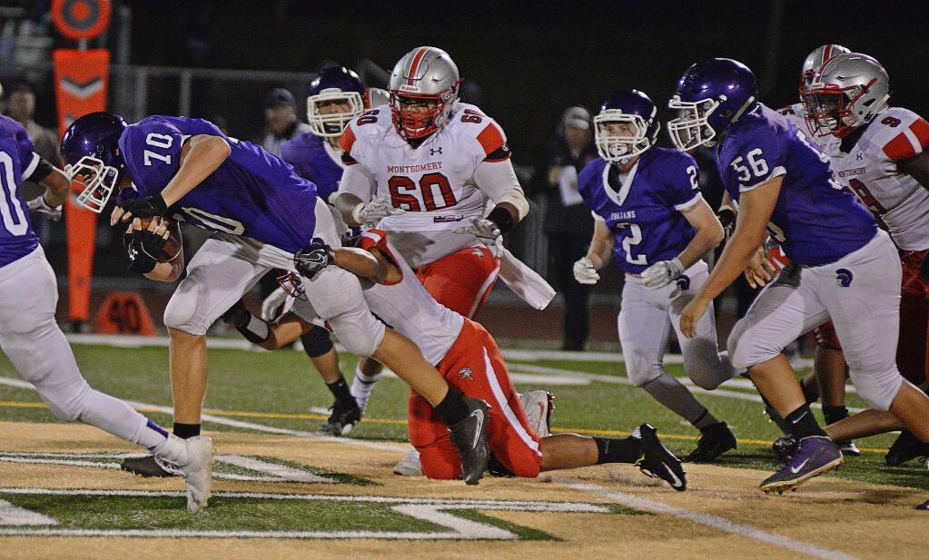 SUMNER FOWLER/FOR THE ARGUS-COURIERPetaluma's outstanding lineman Luke Haggard (70) had a chance to carry the ball in a game against Montgomery. He gained 12 yards on the play.The senior is normally seen blocking or tackling.