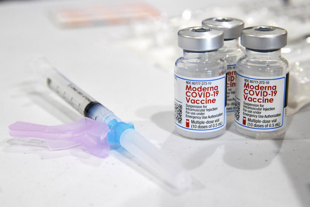 FILE - In this Jan. 9, 2021, file photo, vials of the Moderna COVID-19 vaccine are placed next to a loaded syringe in Throop, Pa. (Christopher Dolan/The Times-Tribune via AP, File)