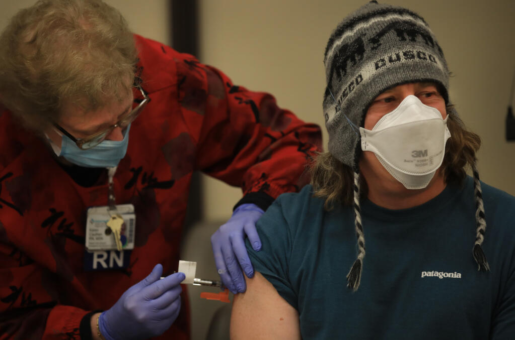 Sutter emergency Department doctor Craig Cohen receives the COVID-19 vaccine from RN Karen Cauthen at Sutter Santa Rosa Regional Hospital, Sunday, Dec. 20, 2020. (Kent Porter / The Press Democrat) 2020