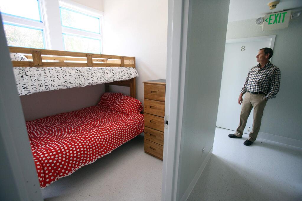 COTS CEO Mike Johnson checking out the new family shelter which includes family bedrooms like the one seen in the photo as well as living, eating, and other amenities at its Petaluma Blvd. South location on Monday, June 8, 2015. (SCOTT MANCHESTER/ARGUS-COURIER STAFF)