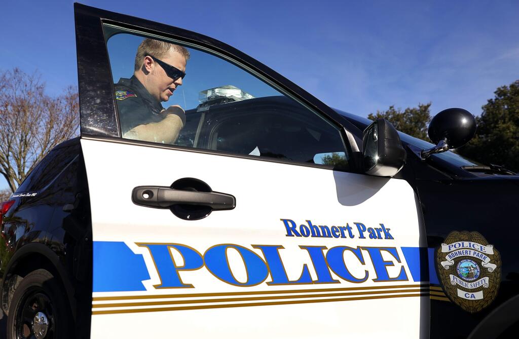 Rohnert Park Public Safety Officer David Wattson calls in a driver's license and registration after pulling a vehicle over in Rohnert Park on Thursday, February 1, 2018. (Christopher Chung / The Press Democrat)