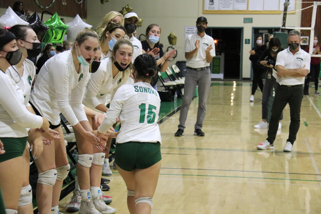 Yuli Lopez (15) low-fives her teammates as she's introduced as a starter for the Sonoma Valley vs. Vintage girls volleyball game on Oct. 12, 2021. The Dragons are entering a playoff round for the NCS Div. 3 title. Head coach Brian Perkins is at right. (Christian Kallen/Index-Tribune)
