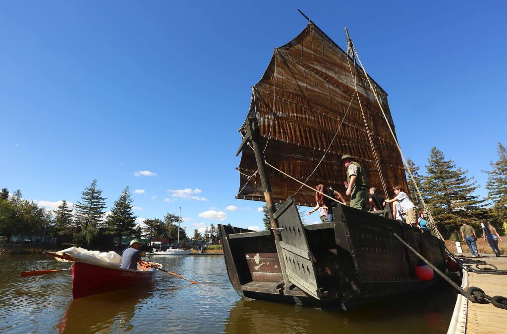 John Rich, left, paddles his sailing dingy past the Grace Quan, a 43-foot replica of a Chinese shrimping junk. The boat, along with the the 1891 schooner the Alma were docked in the Petaluma River turning basin for the River Heritage Days.