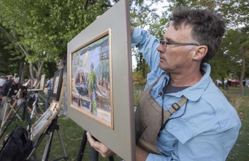 Keith Wicks, founder of Plein Air Sonoma, displays his Quickdraw painting of John the Baker. At Tuesday's Farmers Market and all over the Plaza, Plein Air artists, who'd been painting throughout the county during the week, were given less than two hours to complete a artwork. Their pictures were then gathered together, displayed at First St. West, and put up for sale - all to benefit art education for Sonoma Valley children. (Photos by Robbi Pengelly/Index-Tribune)