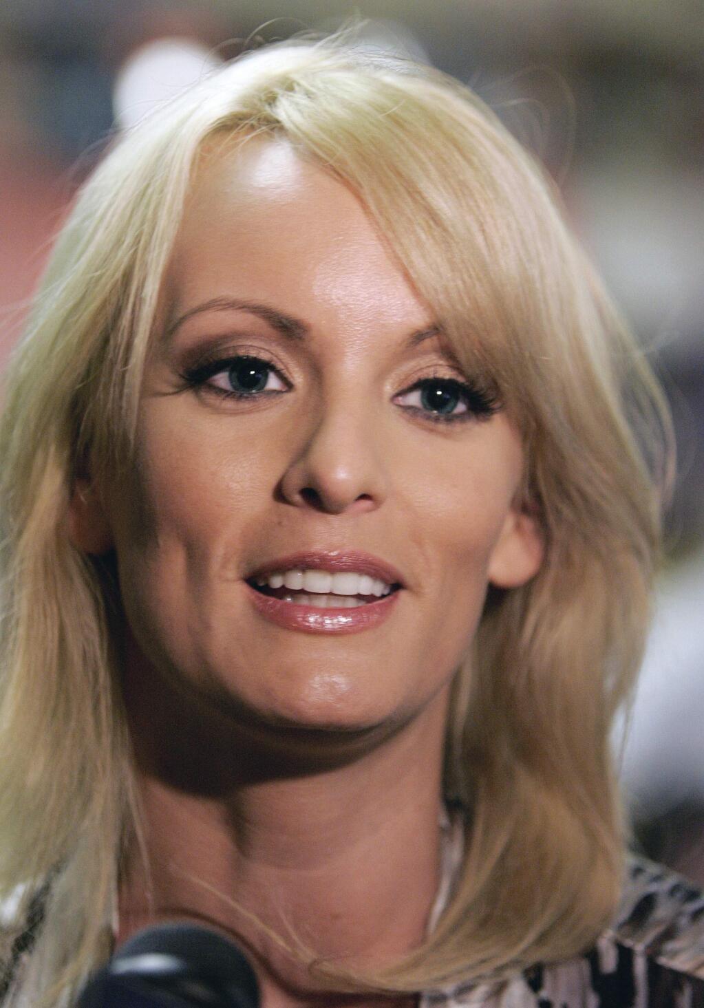 File- This May 6, 2009, file photo shows Stormy Daniels visiting a local restaurant in downtown New Orleans. A tabloid magazine held back from publishing Daniels' 2011 account of an alleged affair with Donald Trump after the future president's personal lawyer threatened to sue, four former employees of the tabloid's publisher told The Associated Press. (AP Photo/Bill Haber, File)