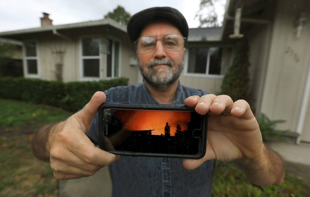 Martin Whiteside was awoken by a neighbor at 1am on Oct. 9, to evacuate his home as the Tubbs fire raced towards Rincon Valley and Santa Rosa. this was the view from his block when he stepped outside that night. There was no notification with his phone or an emergency radio alerting him to the firestorm. (Kent Porter / The Press Democrat) 2017