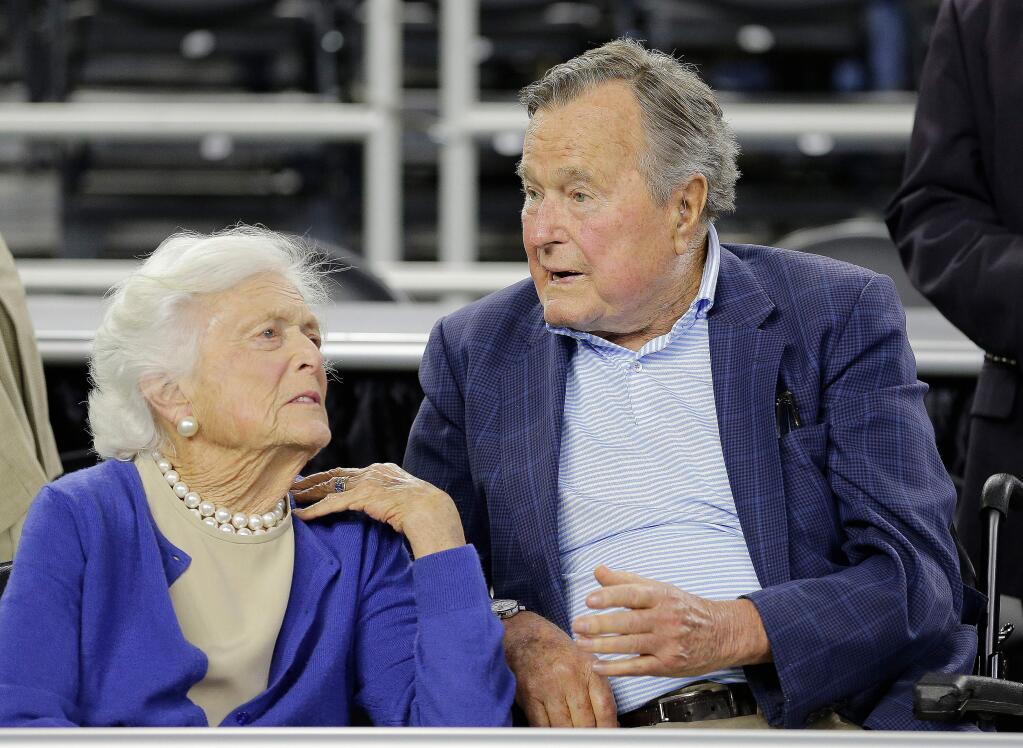 FILE - In this March 29, 2015, file photo, former President George H.W. Bush and his wife Barbara Bush, left, speak before a college basketball regional final game between Gonzaga and Duke, in the NCAA basketball tournament in Houston. A family spokesman said Sunday, April 15, 2018, that the former first lady Barbara Bush is in 'failing health' and won't seek additional medical treatment. (AP Photo/David J. Phillip, File)