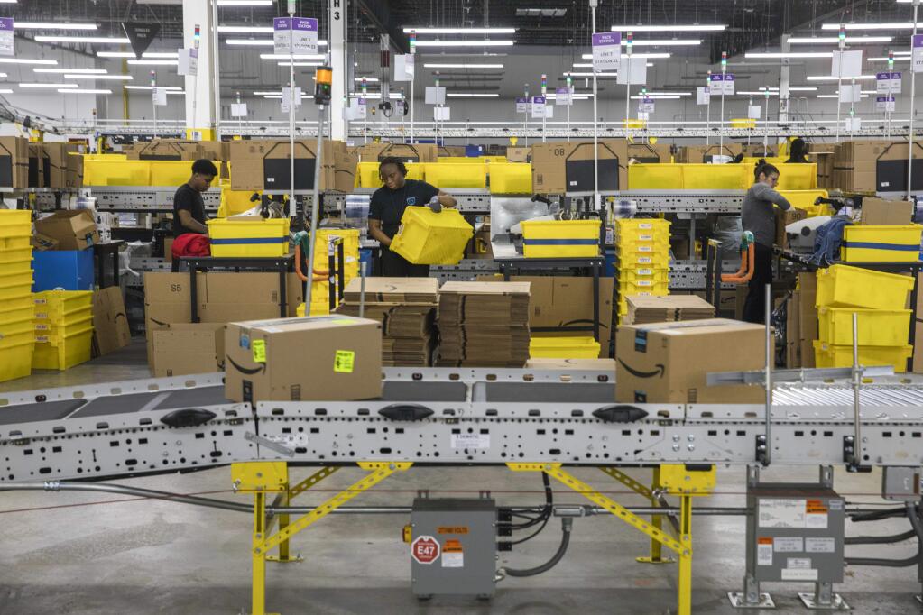 FILE -- Workers at an Amazon fulfillment center in Staten Island, May 15, 2019. Some of Amazon's warehouse employees work as social media ambassadors, responding to critical tweets about the e-commerce giant's punishing working conditions. (Hiroko Masuike/The New York Times)