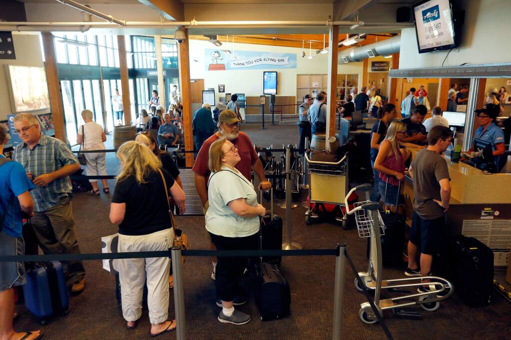 Alaska Airlines passengers check-in for their flights inside the main terminal at Charles M. Schulz-Sonoma County Airport in Santa Rosa, California, on Tuesday, July 11, 2017. (ALVIN JORNADA/ PD)