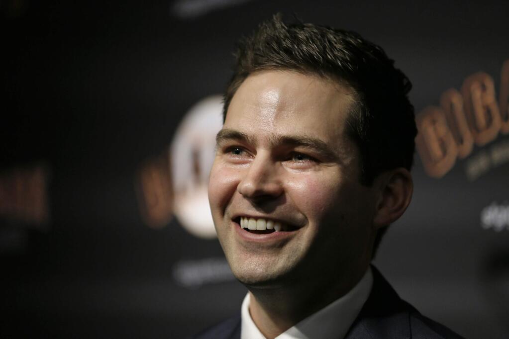 San Francisco Giants general manager Scott Harris smiles during a news conference after his introduction at Oracle Park Monday, Nov. 11, 2019, in San Francisco. The Giants hired Harris from the Chicago Cubs to become general manager, filling a void of more than a year after the club had gone without a GM during president of baseball operations Farhan Zaidi's first season in the position. (AP Photo/Eric Risberg)