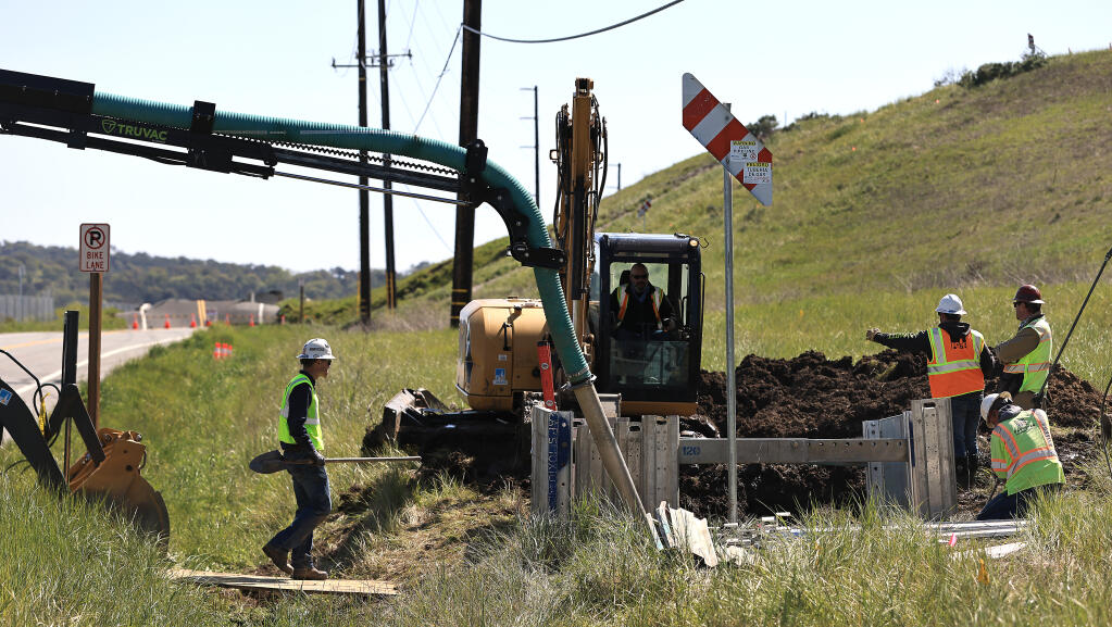 A PG&E subcontract crew dig a bell hole, alongside a gas pipeline that will give space for workers to move the pipeline from the hillside at Olompali State Park that is sliding and reroute it to Highway 101, which will be closed overnight Saturday in to Sunday to accommodate the detour. (Kent Porter / The Press Democrat) 2023
