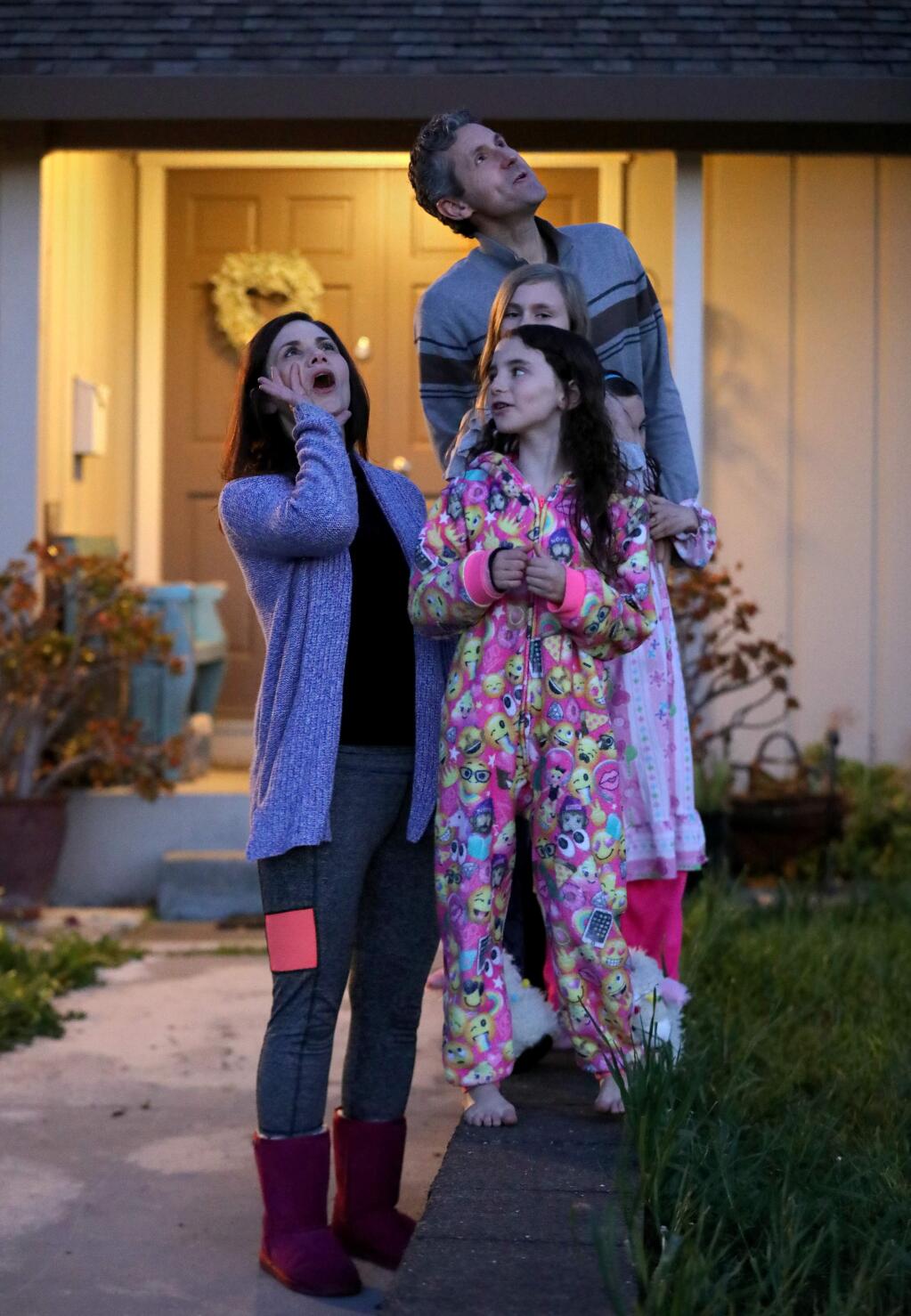 Noelle Mullen, her daughters Tatum, 8, front, Willow, 11, and Fallon, 8, (not seen) and her husband, Dan, join with neighbors and howl outside their home at 8pm in Petaluma on Tuesday, April 7, 2020. (BETH SCHLANKER/ The Press Democrat)