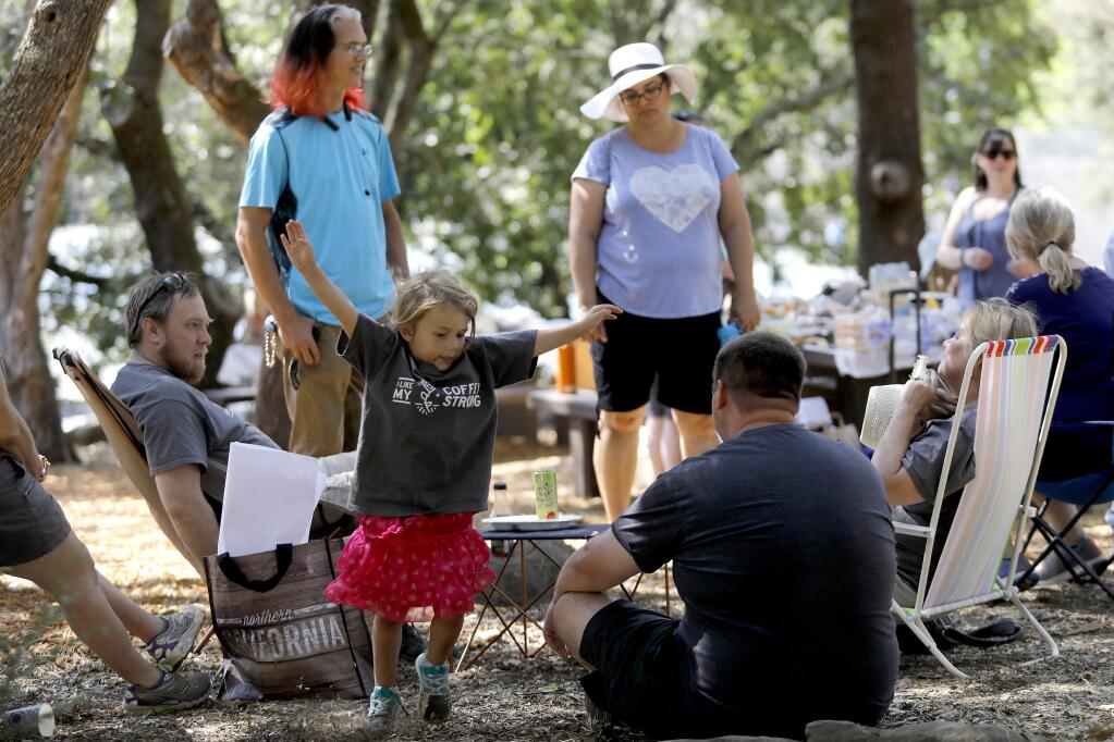 Alexis Kracht, 4, attends a potluck with her family and Coffey Park neighbors at Howarth Park in Santa Rosa on Sunday, August 12, 2018. (Beth Schlanker/ The Press Democrat)