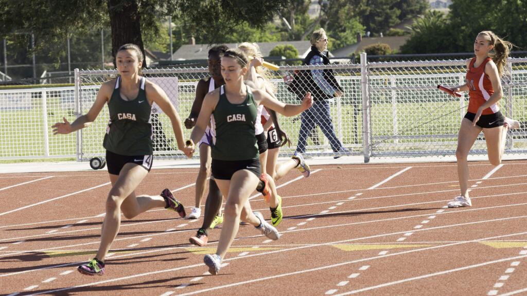 RICH LANGDON/FOR THE ARGUS-COURIERCasa Grande's Jordan Boehning and Annie Gallo exchange the baton in the girls 4x100 relay. The two joined Hannah Barlow and Destiny Williams to win the event at the North Bay League Track and Field Championships.