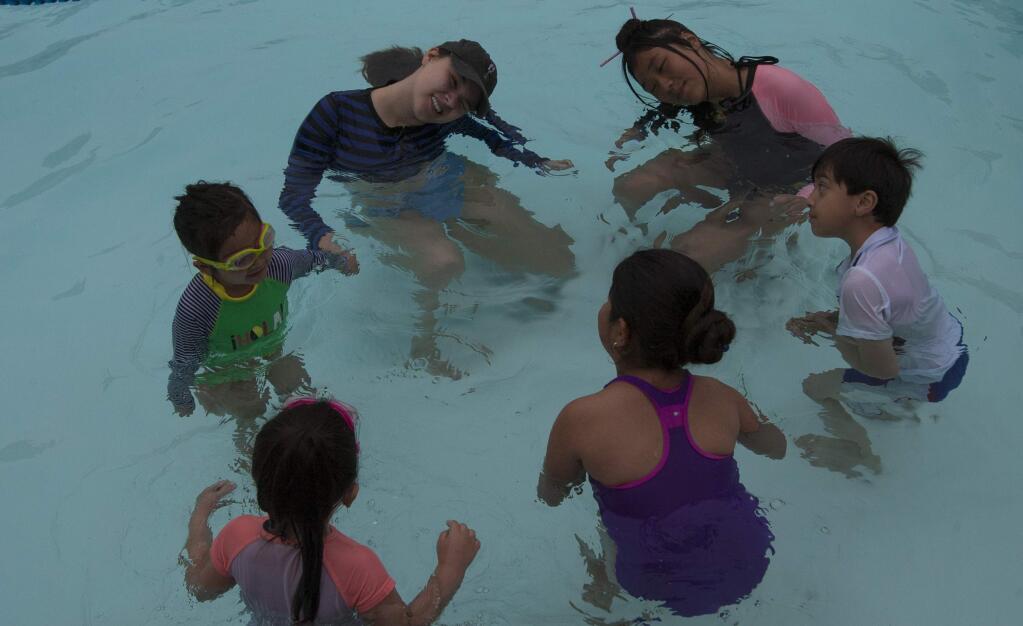 Ryan Debrovner and Rose Brody teach kids swimming and water safety on Saturday, June 15 2019 in Sebastopol, Ca. The classes are offered in English and Spanish to Sonoma County residents. (Frankie Frost / For The Press Democrat)
