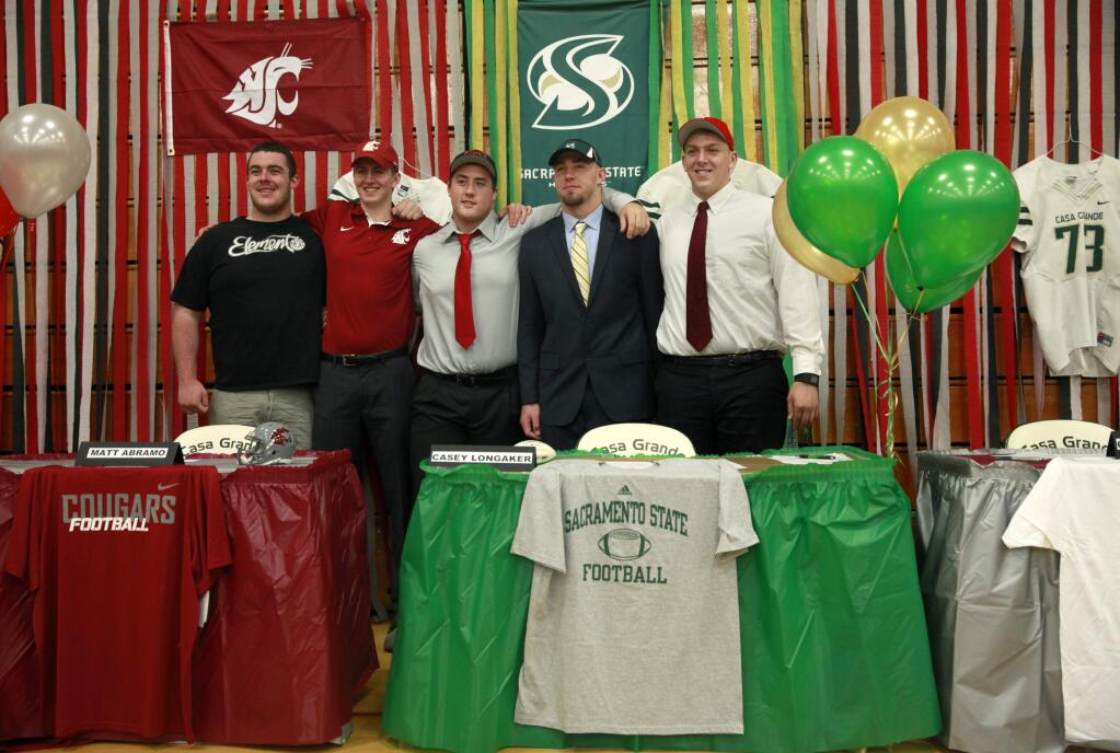 (From left) Casa Grande senior football players Peter Parrick, 17, Matt Abramo, 17, Brendan Jackson, 17, Casey Longaker, 18, and Greg Poteracke, 17, pose for a photo after all but Parrick signed their National Letters of Intent at Casa Grande High School on Wednesday, February 4, 2015 in Petaluma, California . (BETH SCHLANKER/ The Press Democrat)