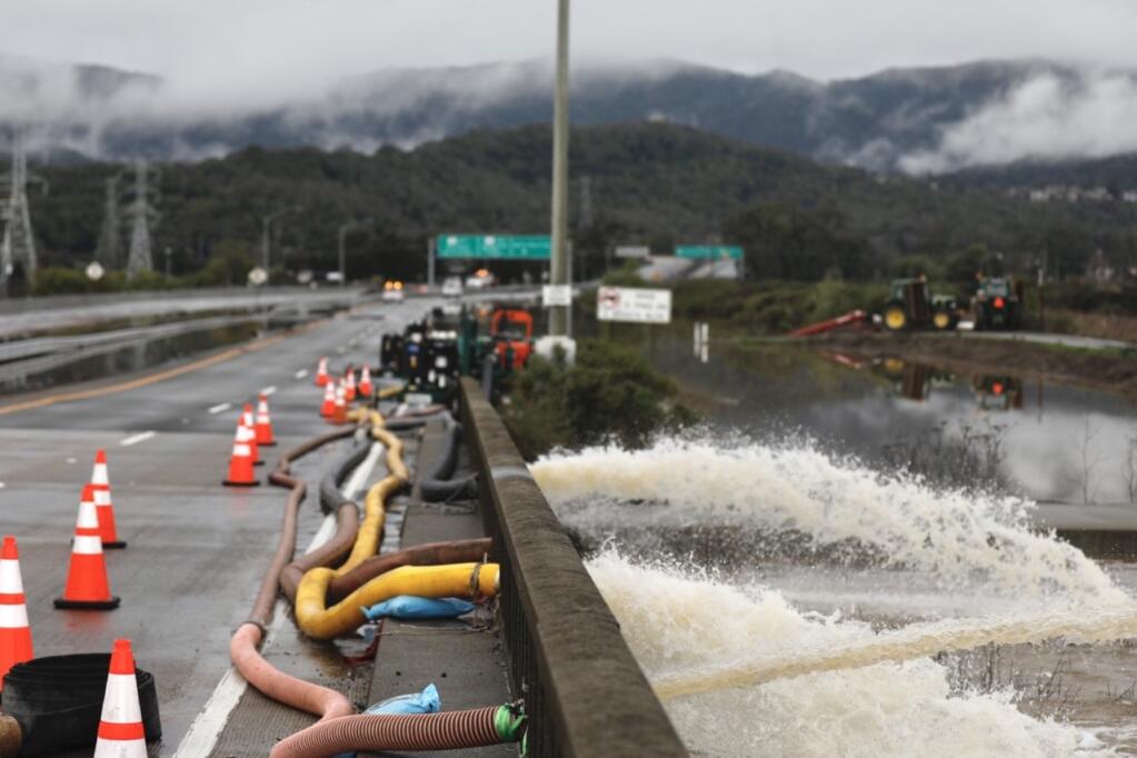 Flood water is pumped off Highway 37 in Novato Sunday, Jan. 15, 2023. Authorities shut down a portion of the highway due to flooding between Highway 101 and Atherton Avenue. (Beth Schlanker / The Press Democrat file)