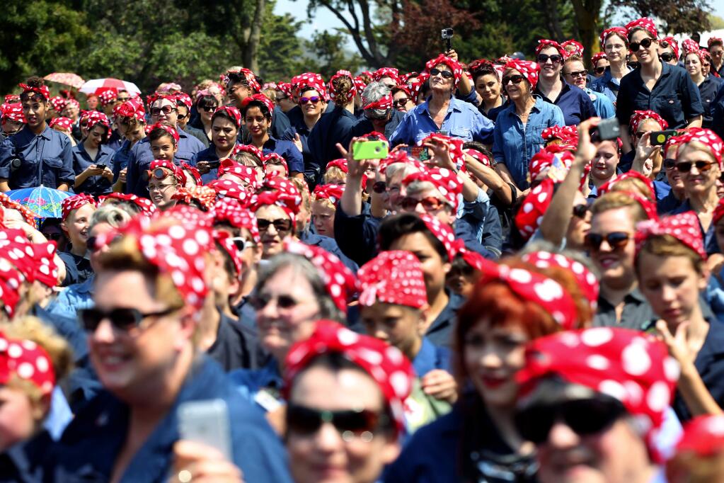 Hundreds of women dressed as 'Rosie the Riveter' gather in an attempt to set a new Guinness World Record at Rosie the Riveter/WWII Home Front National Historical Park in Richmond, Saturday, Aug. 15, 2015. The current record was set last year when 776 Rosie and Rosie lookalikes gathered at the Willow Run Airport in Ypsilanti, Mich. (Anda Chu/The Contra Costa Times via AP)