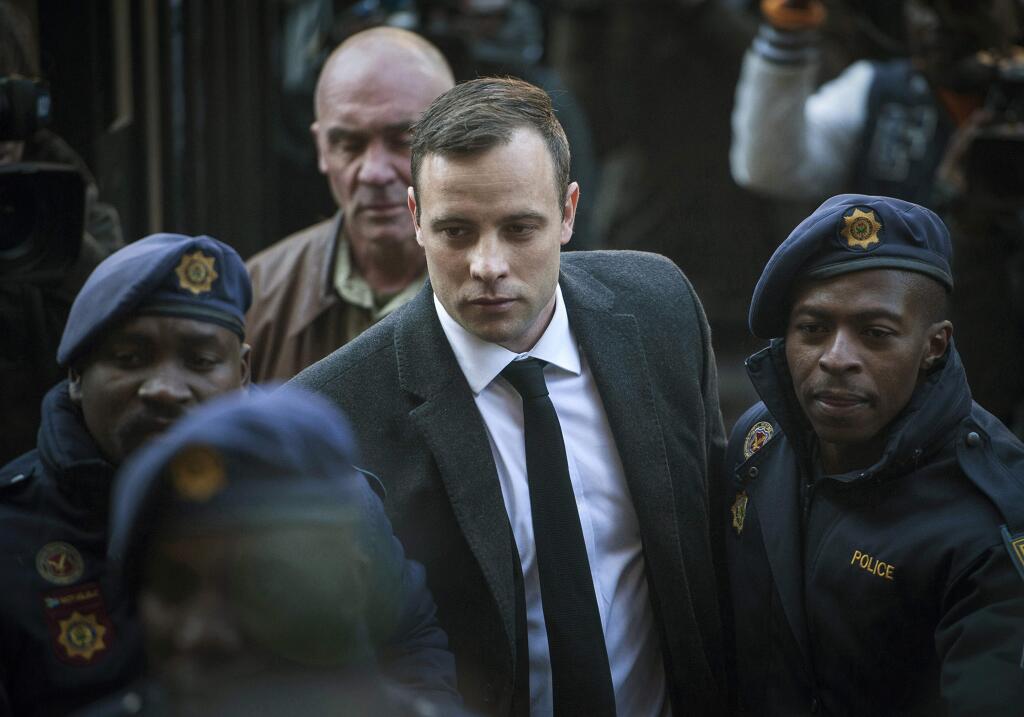 FILE - In this July 6, 2016, file photo, Oscar Pistorius, center, arrives at the High Court in Pretoria, South Africa, for a sentencing hearing for the murder of his girlfriend Reeva Steenkamp in his home on Valentine's Day 2013. Pistorius has had his prison sentence extended to 13 years and 5 months in the High Court of Appeal in Bloemfontein Friday, Nov. 24, 2017. (AP Photo/Shiraaz Mohamed, File)