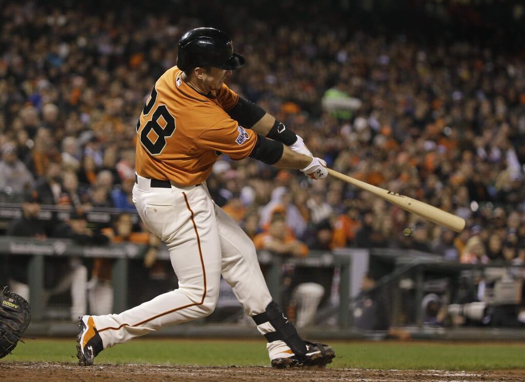 San Francisco Giants' Buster Posey hits an RBI double off Atlanta Braves relief pitcher Jim Johnson in the eighth inning of a game Friday, May 29, 2015, in San Francisco. (AP Photo/Eric Risberg)
