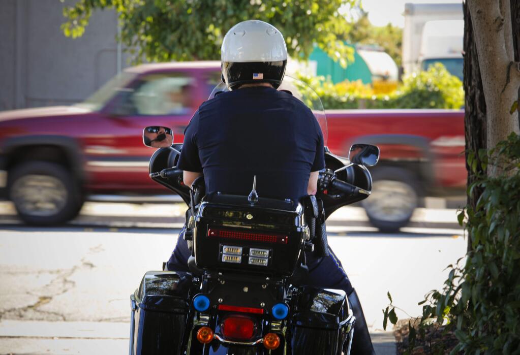 The Petaluma Police Department recently received a grant worth $105,000 to help with their traffic unit. Motor Officer Matt Frick keeps a watchful eye on East Washington Street for drivers illegally holding their cellphones. (CRISSY PASCUAL/ARGUS-COURIER STAFF)