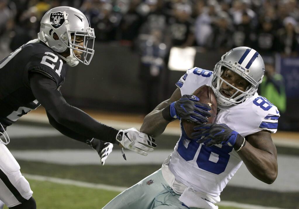Dallas Cowboys wide receiver Dez Bryant (88) catches a pass against Oakland Raiders cornerback Sean Smith (21) during the second half of an NFL football game in Oakland, Calif., Sunday, Dec. 17, 2017. The Cowboys won 20-17. (AP Photo/Eric Risberg)