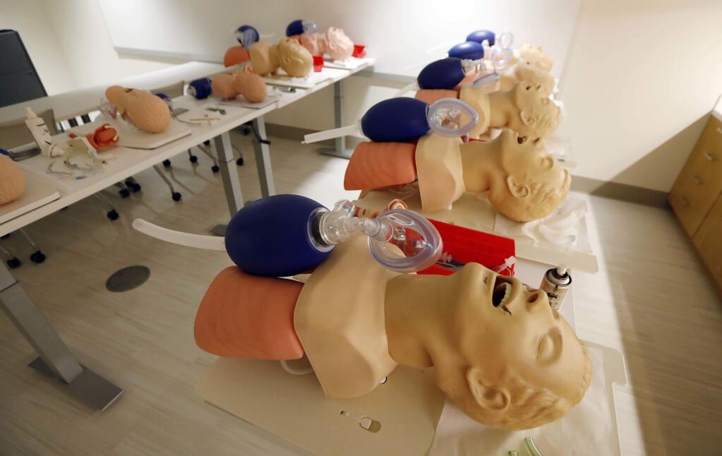 FILE - In this Friday, Aug. 4, 2017 file photo, mannequins are arranged to train CPR to incoming medical students in Jackson, Miss. A study released on Sunday, Nov. 12, 2017 shows women are less likely than men to get CPR from a bystander and more likely to die, and researchers think that reluctance to touch a woman's chest may be one reason. (AP Photo/Rogelio V. Solis)