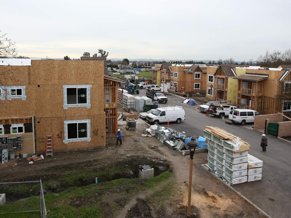 Crews work on an affordable housing project under construction in Santa Rosa in 2015. (PD FILE)