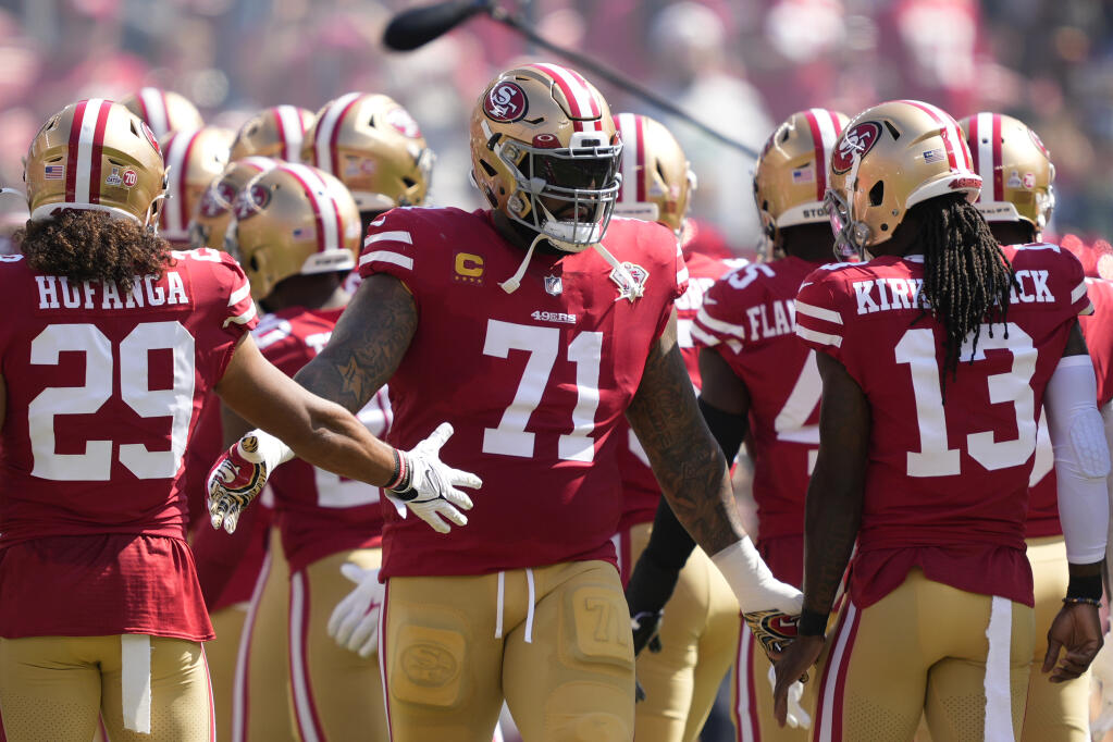 San Francisco 49ers offensive tackle Trent Williams, center, greets teammates before a game against the Seattle Seahawks in Santa Clara on Sunday, Oct. 3, 2021. (Tony Avelar / ASSOCIATED PRESS)