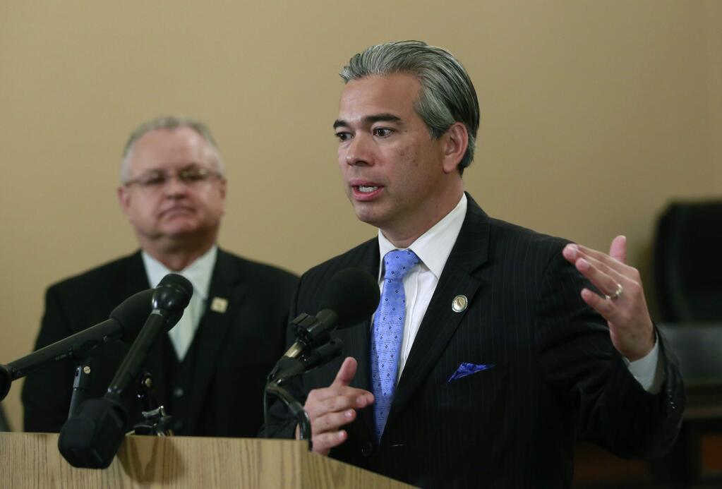 Assemblyman Rob Bonta, D-Oakland, right, discusses the measure he and Assemblyman Tom Lackey, R-Palmdale right, are proposing to cut taxes on legal marijuana, Thursday, March 15, 2018, in Sacramento, Calif. The lawmakers say current taxes are so high that users often find it cheaper to keep buying illegal products from the black market. (AP Photo/Rich Pedroncelli)