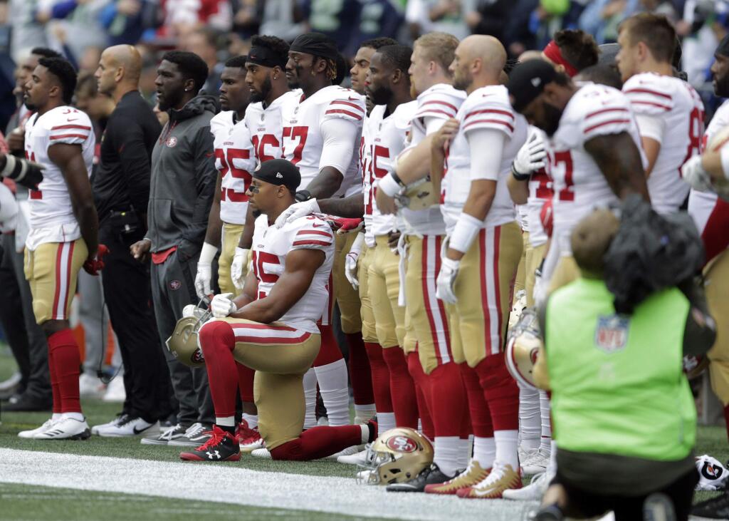 San Francisco 49ers strong safety Eric Reid kneels during the singing of the national anthem before a game against the Seattle Seahawks, Sunday, Sept. 17, 2017, in Seattle. (AP Photo/John Froschauer)
