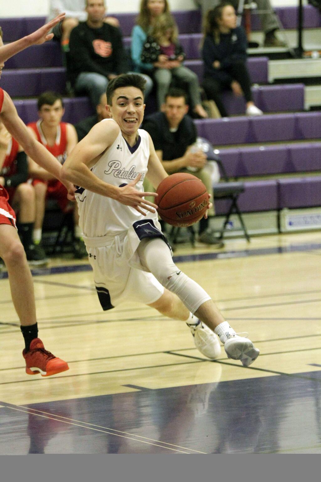 DWIGHT SUGIOKA/FOR THE ARGUS-COURIERPetaluma's Robbie Isetta drives to the hoop. The 3-year varsity veteran returns to lead the Trojans into the VVAL.