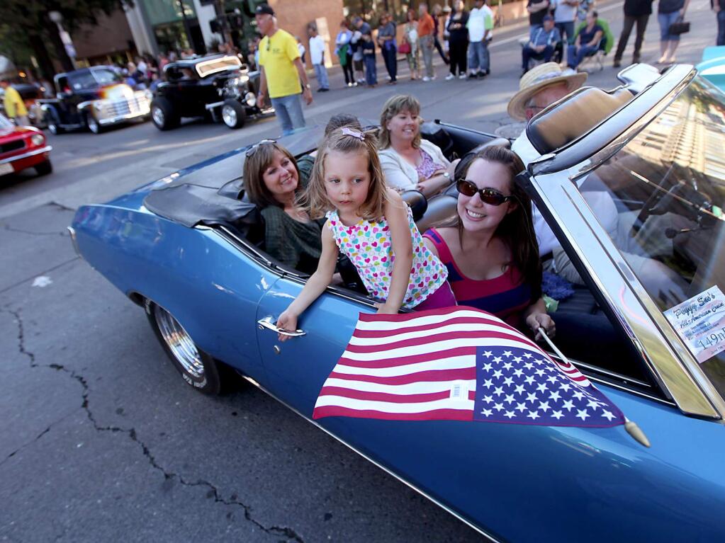 Caitlyn Baker and mom, Zoe Baker, tool around in Don Roberts 1970 Buick Skylark during Peggy Sue's All-American Cruise in downtown Santa Rosa in 2012. Background left are Donna Jones and Melinda Bartel. (KENT PORTER/ PD FILE)
