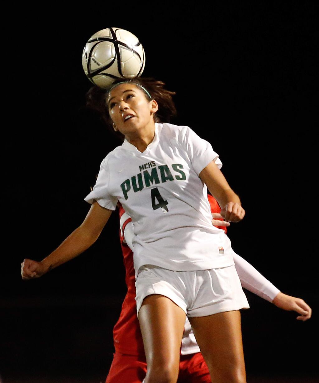 Maria Carrillo's Maddy Gonzalez (4) gets up for a header during the first half of the NCS Division 1 championship girls soccer match between Maria Carrillo and Montgomery high schools in Santa Rosa, California on Saturday, November 14, 2015. (Alvin Jornada / The Press Democrat)