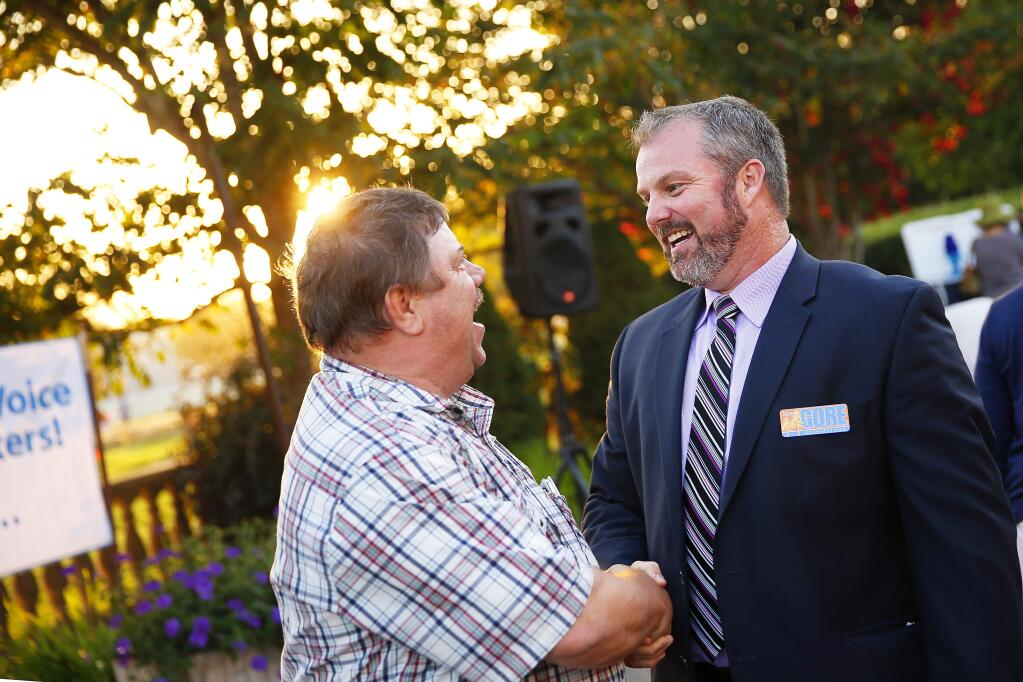 (File photo) Sonoma County Supervisor James Gore, right, pictured when he was a candidate for office, speaking with his supporters during a campaign kickoff party at Kendall-Jackson Wine Estate & Garden in Santa Rosa on Friday, September 5, 2014. (Conner Jay/The Press Democrat)