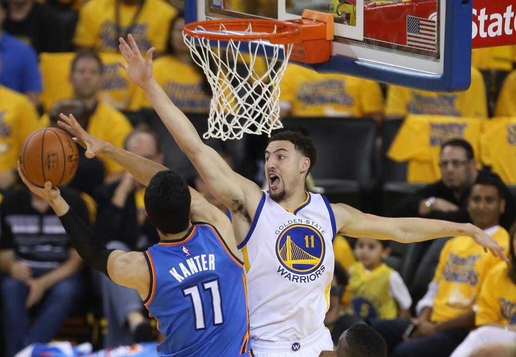 Golden State Warriors' Klay Thompson defends against Oklahoma City Thunder's Enes Kanter, during their game in Oakland on Monday, May 30, 2016. (Christopher Chung/ The Press Democrat)