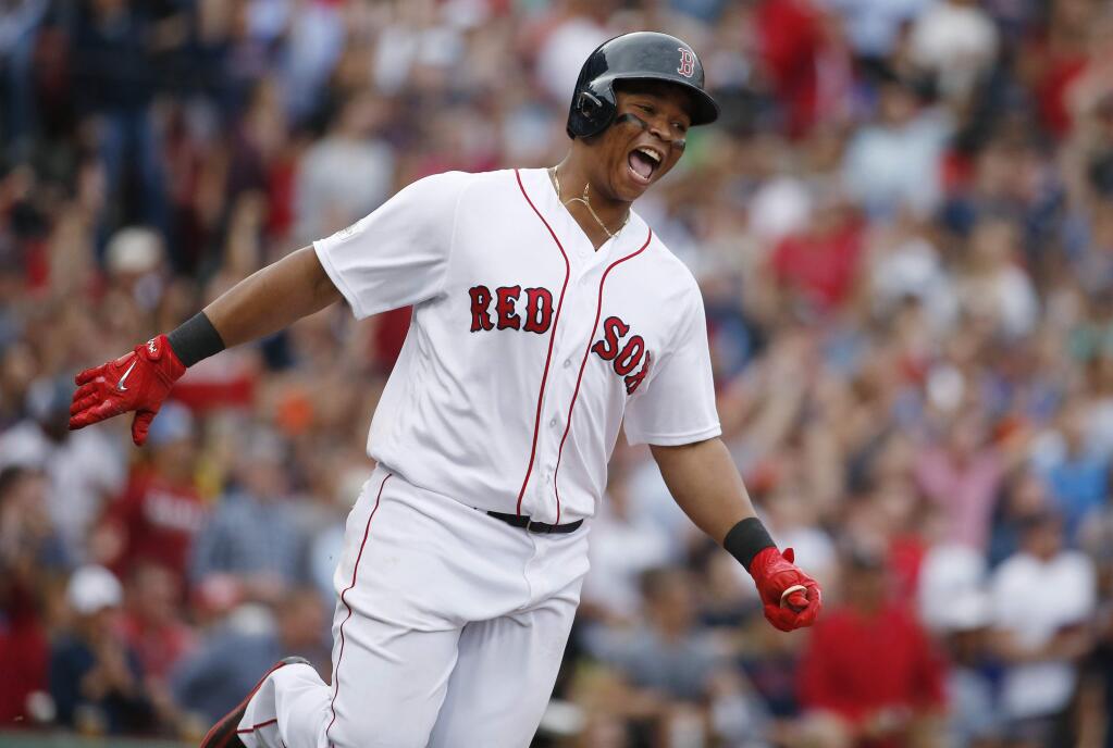 Boston Red Sox's Rafael Devers celebrates his two-run home run against the Houston Astros as he runs the bases during the third inning in Game 3 of baseball's American League Division Series, Sunday, Oct. 8, 2017, in Boston. (AP Photo/Michael Dwyer)
