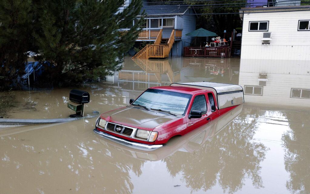 A truck sits submerged in floodwaters in Forestville, Calif., on Thursday, Feb. 28, 2019. (AP Photo/Josh Edelson)