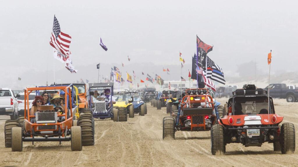 In this Sunday, Aug. 18, 2018, photo hundreds of dune buggies parade along the Oceano Dunes State Recreational Vehicle Area, the line stretching south to north in Oceano, Calif. The California Coastal Commission has decided on Thursday, July 11, 2019, not to make any immediate changes to the rules for off-road vehicle use at Oceano Dunes. Oceano Dunes, which draws roughly 2 million visitors a year, is the only oceanfront state park that allows vehicles on its sand. (David Middlecamp/The Tribune (of San Luis Obispo) via AP)