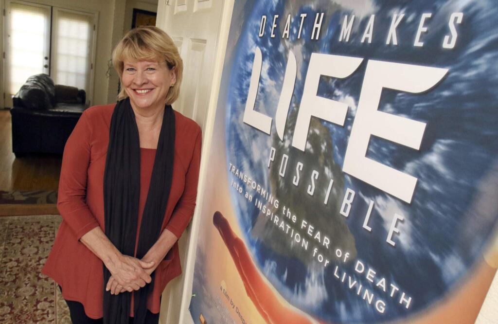 Marilyn Schlitz with the poster for her movie 'Death makes life possible' in her petaluma home on Tuesday, July 28, 2015. (SCOTT MANCHESTER/ARGUS-COURIER STAFF)