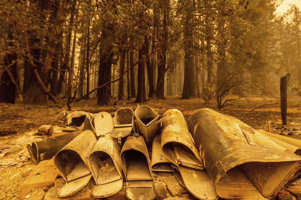 Following the Dixie fire, scorched mailboxes rest on the ground in the Indian Falls community of Plumas County, Calif., on Sunday, July 25, 2021. (AP Photo/Noah Berger)