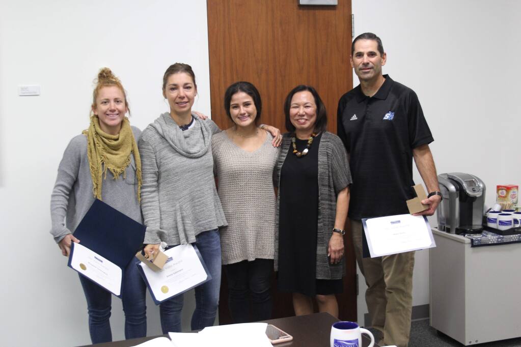 Sonoma State University President Judy Sakaki (second from right) presents the SSU women's soccer coaching staff of assistant coach Margi Osmundson (far left), head coach Emiria Salzmann Dunn (second from left) and assistant coach Mark Dunn (far right) with the first-ever Valor Award after saving the life of senior Courtney Shoda (center) when she collapsed during a training session in Arcata earlier this year.